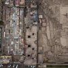 Residences and a market next to Huaca Huantille in Lima; photo: AP