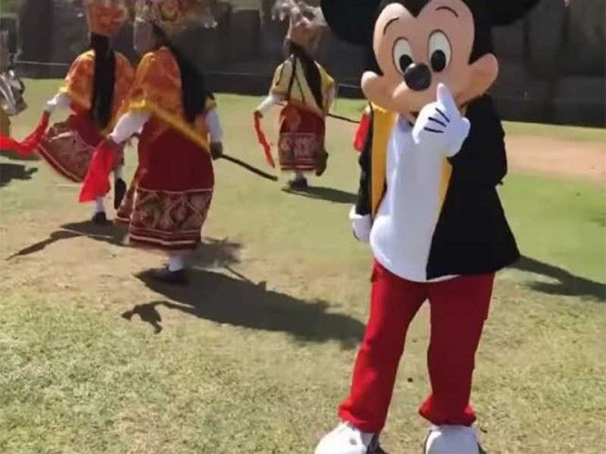 Mickey Mouse joining locals for a traditional dance at the Sacsayhuaman ruins in Cusco, Peru; photo: FB video